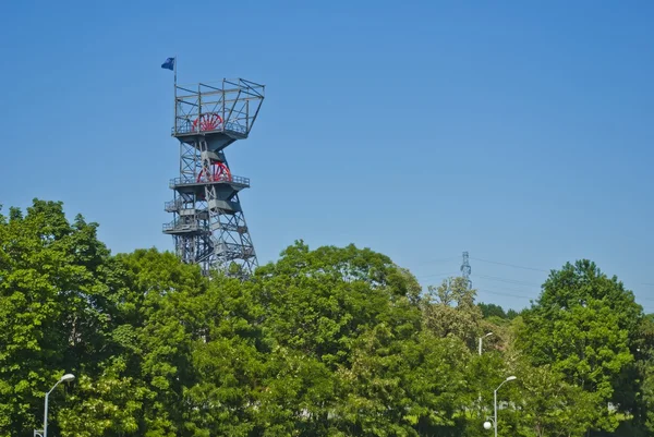 Coal Mine Shaft Tower, Nature and Industry with Trees and Blue Sky — Stock Photo, Image
