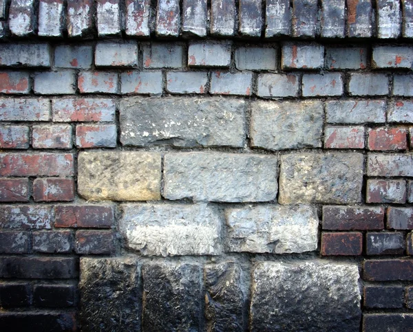 Oude stenen muur gevuld met bakstenen textuur — Stockfoto