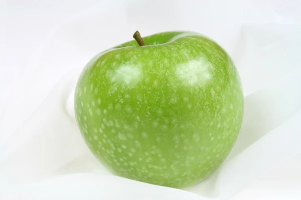 Jabłko na tło włókienniczych — Zdjęcie stockowe