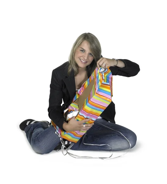 Roztomilá dívka sedící rozvinutím dárek — Stock fotografie