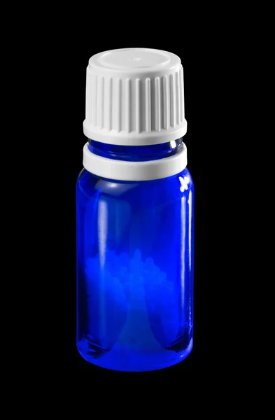 Small bottle with globules — Stock Photo, Image
