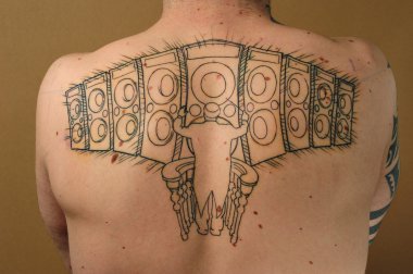 Speakers tattooed on the back clipart