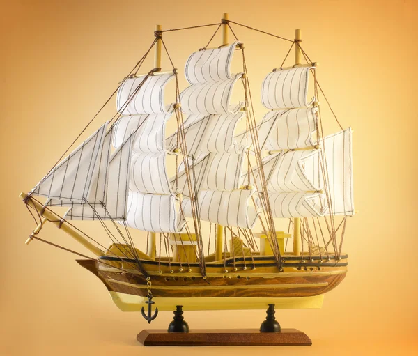 Sailing ship on yellow — Stock Photo, Image