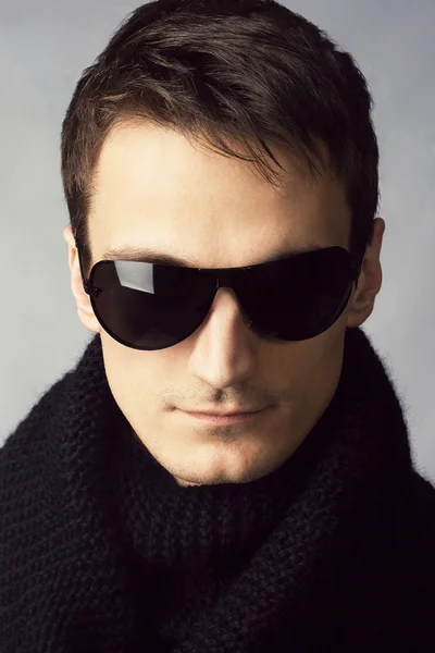 stock image Handsome man in sunglasses and black scarf