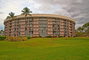 Palm trees in front of a tropical resort in Kona clipart