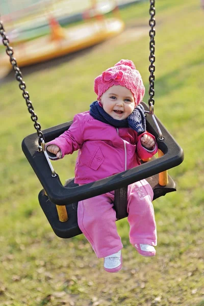 stock image Happy baby playing with the swing