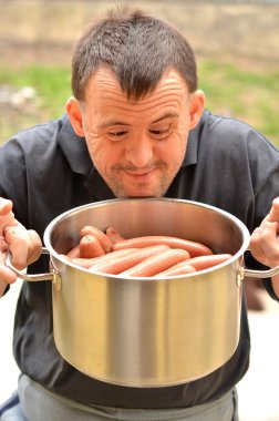 Down syndrome man with sausage clipart