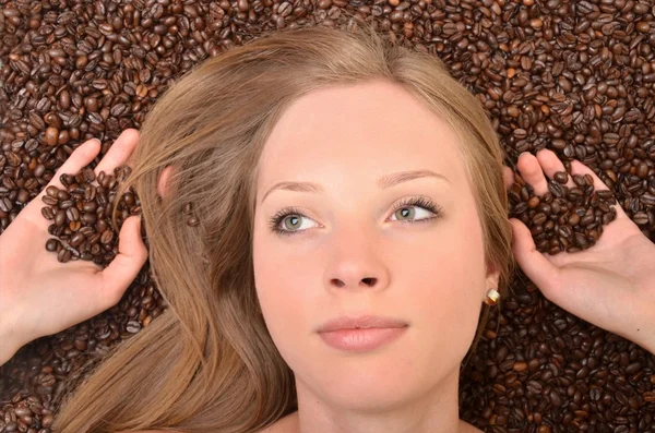 Woman with coffee beans — Stock Photo, Image