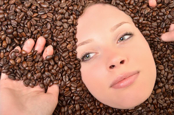 Woman in coffee beans — Stock Photo, Image