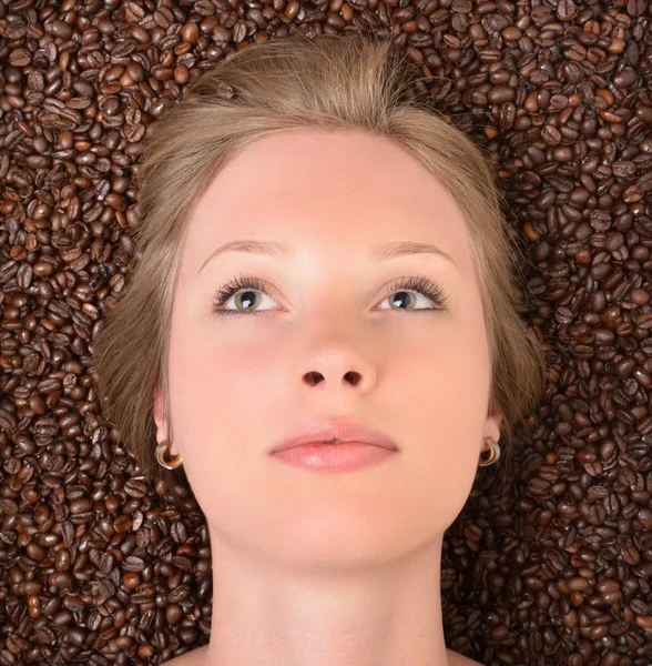 Woman in coffee beans — Stock Photo, Image