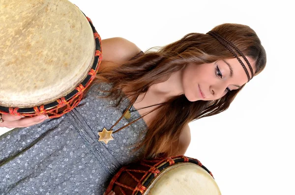 Pretty girl playing the drums or tom toms with her hands — Stock Photo, Image