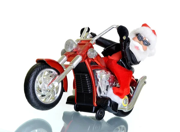 Weihnachtsmann auf einem Motorrad vor weißem Hintergrund — Stockfoto