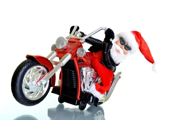 Papai Noel de pé em uma motocicleta em um fundo branco — Fotografia de Stock