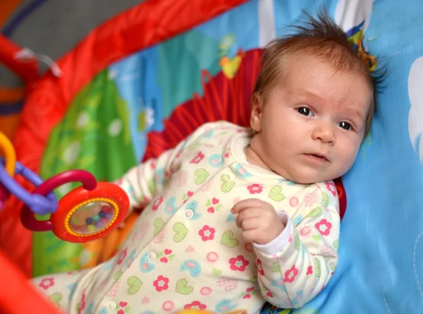 Happy baby playing in baby gym toy — Stock Photo, Image