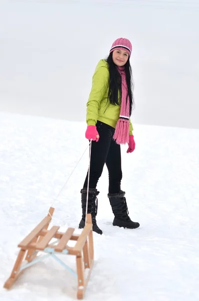 stock image Young woman with sled