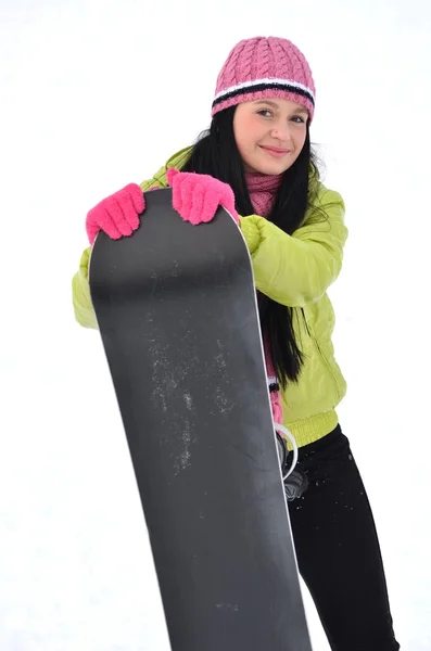 Woman with snowboard standing on top of snowy mountain — Stock Photo, Image