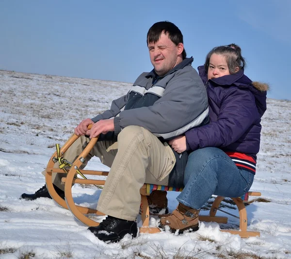 stock image Down syndrome couple sledding