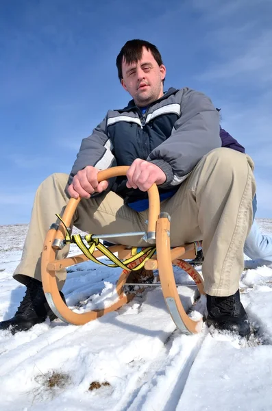 Man with down syndrome sledding — Stock Photo, Image