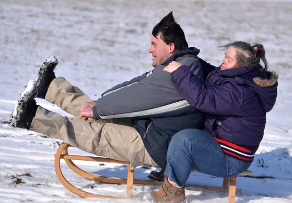 stock image Down syndrome couple sledding