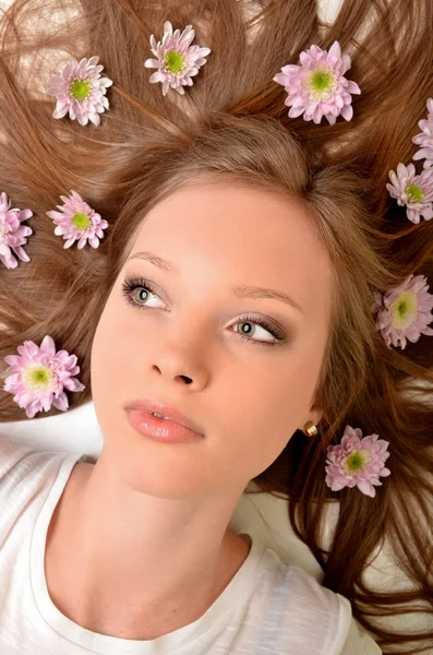 stock image Beautiful young woman with gerber flower isolated on white background