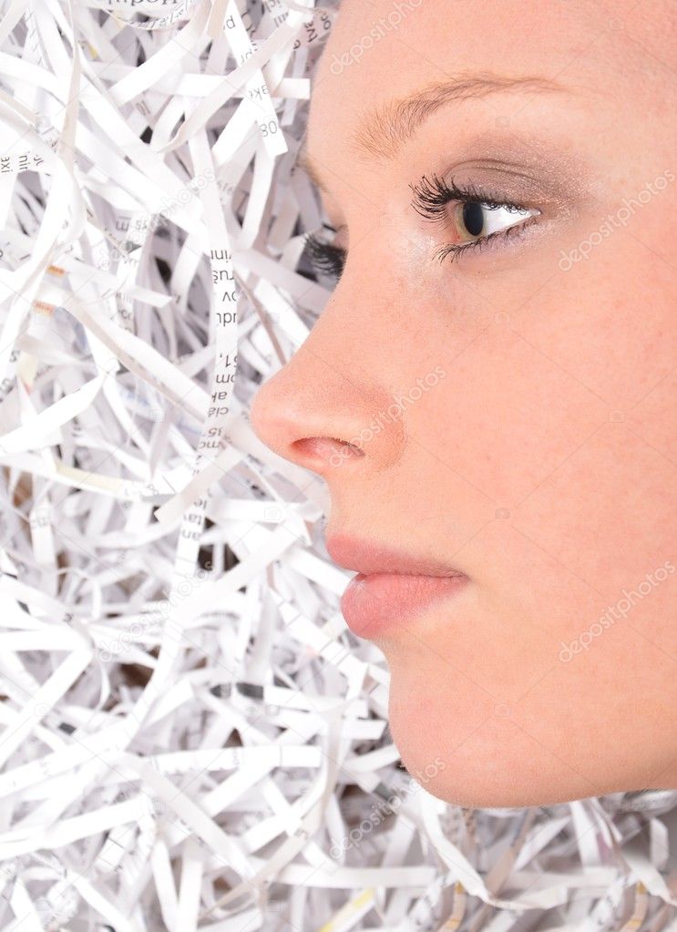Young Businesswoman covered by shredded papers