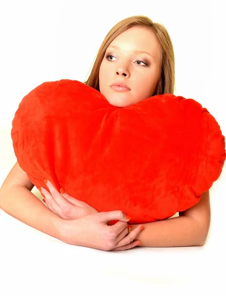 Valentine's Day. Beautiful smiling woman with a gift in the form of he — Stock Photo, Image