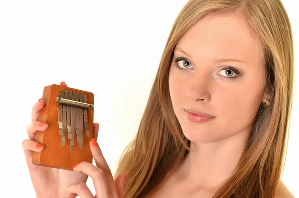 Relaxed woman playing on a version of the African instrument Kalimba — Stock Photo, Image