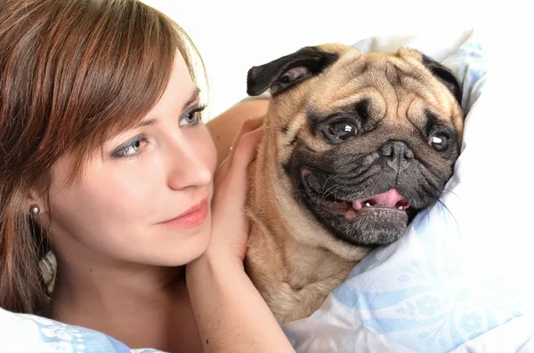 Woman with pug in bed — Stock Photo, Image
