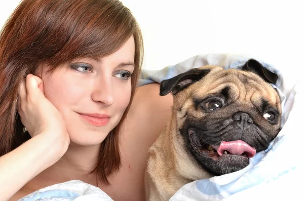 stock image Woman and her dog comfortably sleeping in the bed