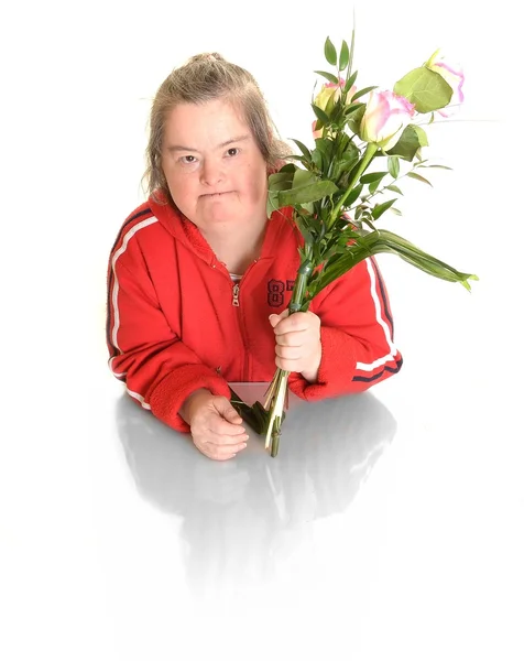 Down syndrome woman with flowers — Stock Photo, Image