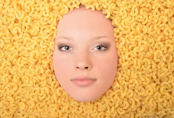 Portrait of a young beautiful woman in pasta — Stock Photo, Image