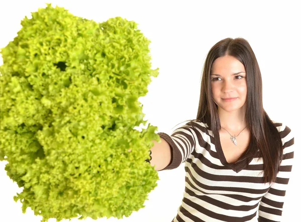 Happy young woman holding green lettuce and smiling, over white background — Stock Photo, Image