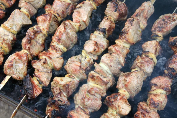 Tasty grilled meat on skewers — Stock Photo, Image