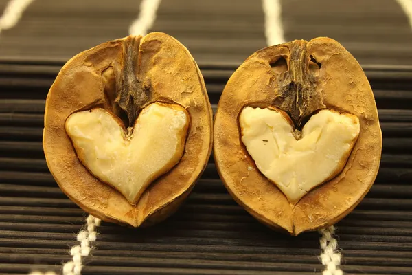 stock image Two nuts with abstract hearts for Valentine's Day