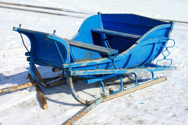 The old wooden sledge against the snow