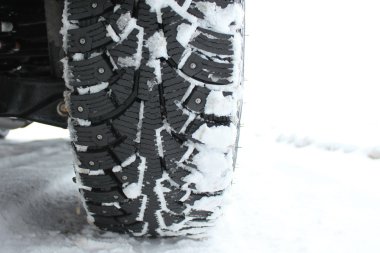 Studded snow tires in the winter clipart