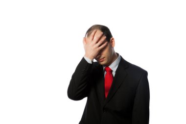 Despaired businessman with face in his palm clipart