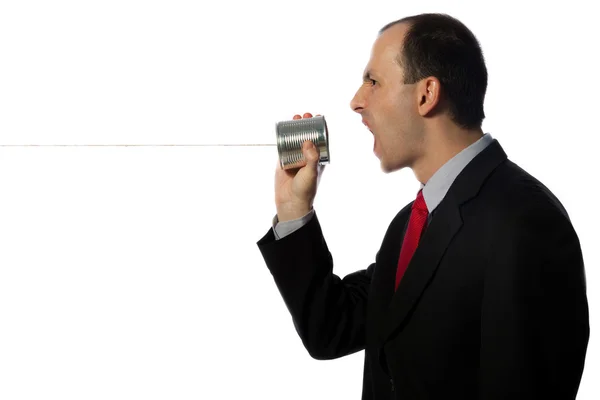 Businessman yelling through an oldschool can phone, horizontal, — Stock Photo, Image