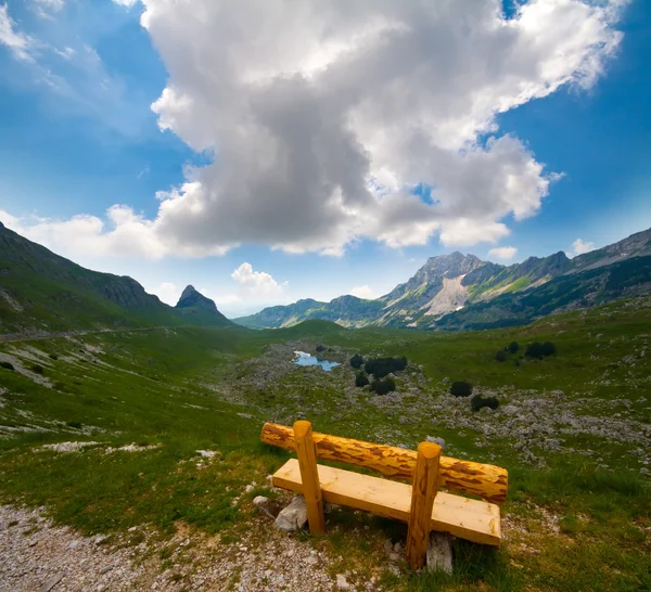 stock image Solitary bench on Alps valley