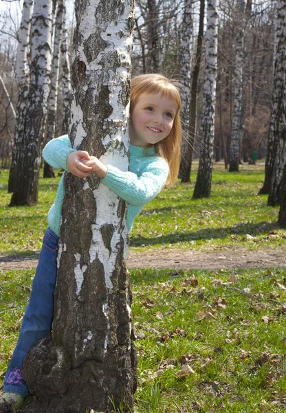 Smiling girl in birch grove — Stock Photo, Image