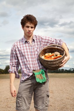 Young agriculturist on the cultivated field clipart