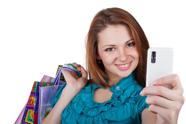 Mooie vrouw met shopping tassen en telefoon — Stockfoto