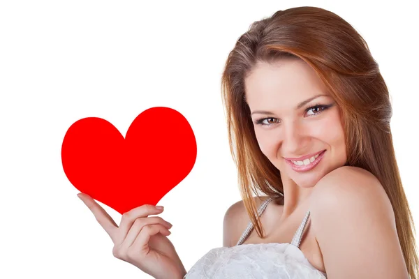 Smiling young woman holding a heart — Stock Photo, Image