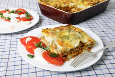 Lasagne verde and caprese salad clipart