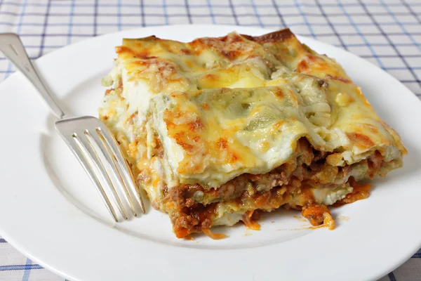 Lasagne slice with fork — Stock Photo, Image