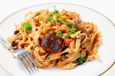 Eggplant in tomato sauce with pasta clipart