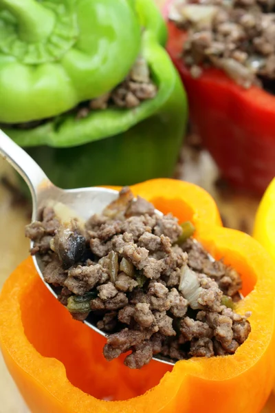 Stuffing colourful peppers vertical — Stock Photo, Image