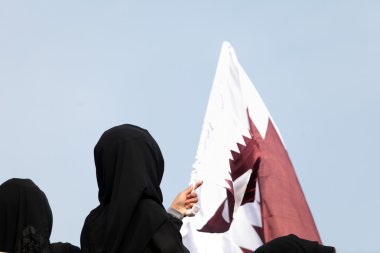 Covered women and Qatar flag clipart
