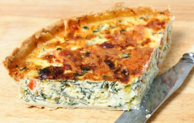 Spinach quiche on a board clipart