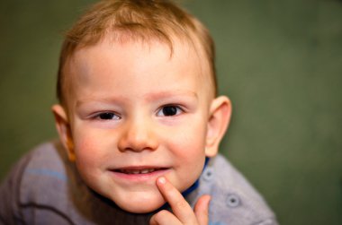 Little boy interrogatively looks upwards clipart